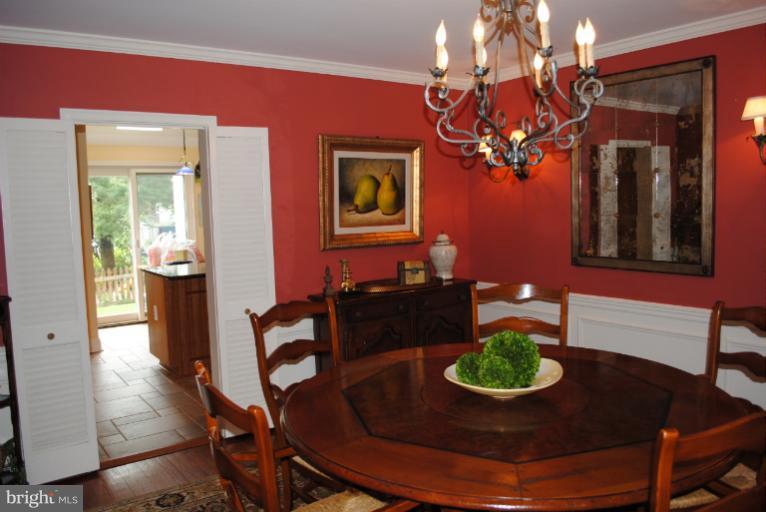 5803 Kenmore Road Baltimore, MD 21210 - Photo 11 of 29 a view of a dining room with furniture and wooden floor