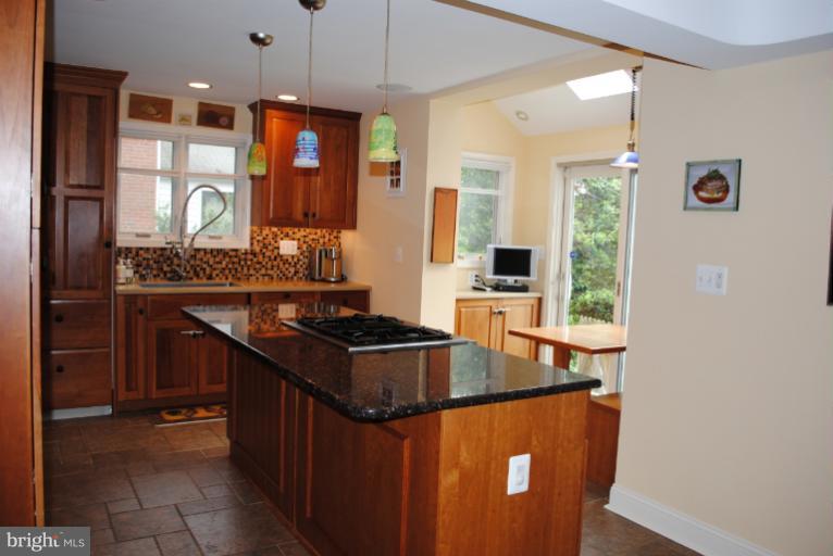5803 Kenmore Road Baltimore, MD 21210 - Photo 12 of 29 a kitchen with stainless steel appliances granite countertop a sink a stove and a refrigerator