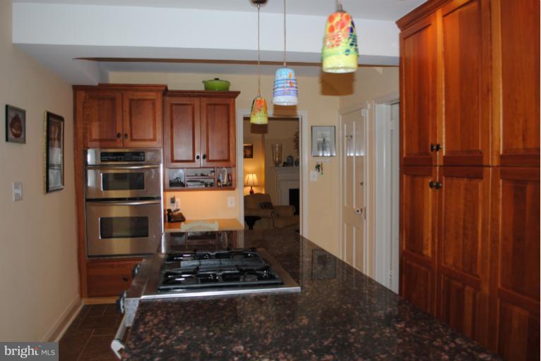 5803 Kenmore Road Baltimore, MD 21210 - Photo 14 of 29 a kitchen with wooden cabinets and appliances
