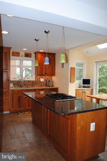 5803 Kenmore Road Baltimore, MD 21210 - Photo 15 of 29 a kitchen with stainless steel appliances granite countertop a sink a stove counter space and a window