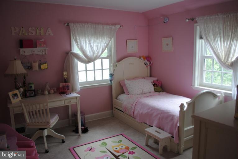 5803 Kenmore Road Baltimore, MD 21210 - Photo 18 of 29 a bedroom with a bed chair and a window