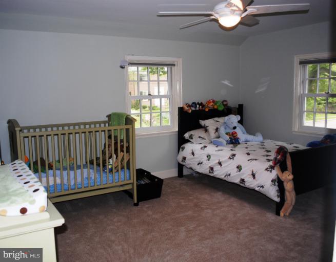 5803 Kenmore Road Baltimore, MD 21210 - Photo 3 of 29 a bedroom with a bed and a window