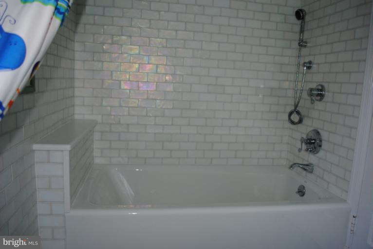 5803 Kenmore Road Baltimore, MD 21210 - Photo 21 of 29 a close up of a bathtub in a bathroom