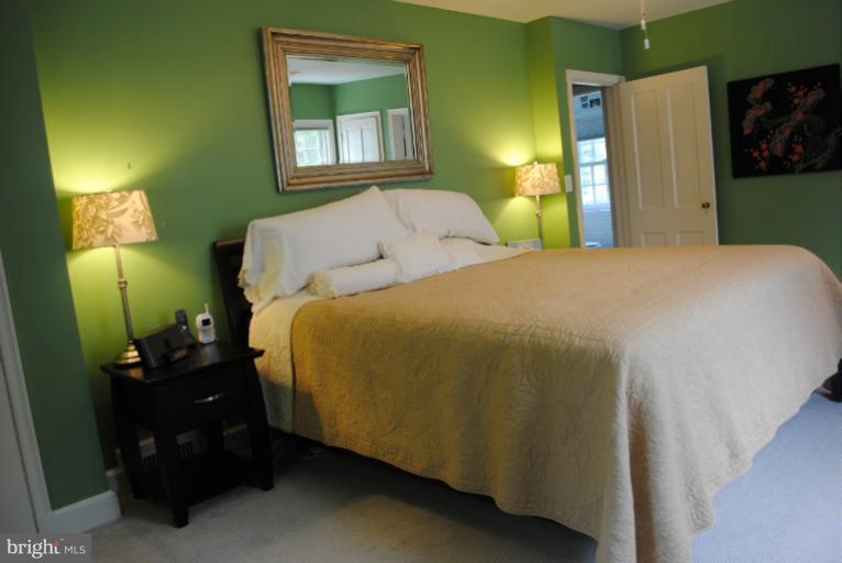 5803 Kenmore Road Baltimore, MD 21210 - Photo 23 of 29 a bedroom with a bed and a lamp
