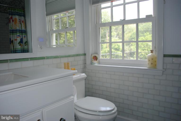 5803 Kenmore Road Baltimore, MD 21210 - Photo 25 of 29 a bathroom with a toilet sink and window