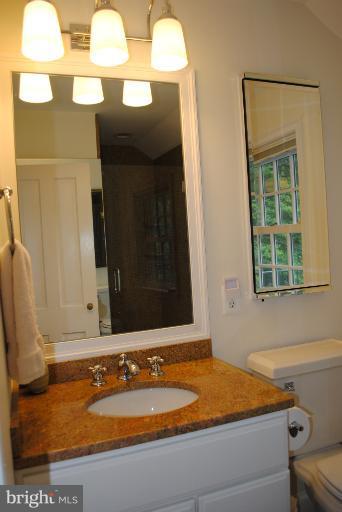 5803 Kenmore Road Baltimore, MD 21210 - Photo 27 of 29 a bathroom with a sink and a mirror