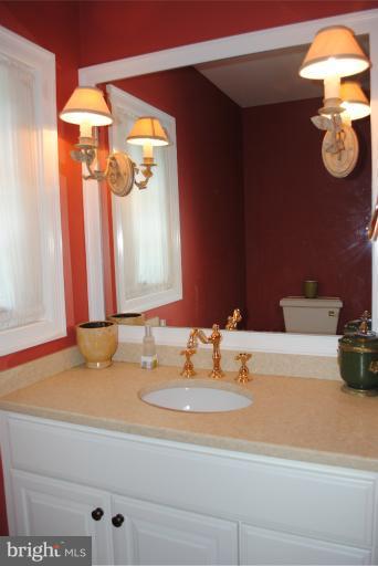 5803 Kenmore Road Baltimore, MD 21210 - Photo 6 of 29 a bathroom with a sink and a mirror