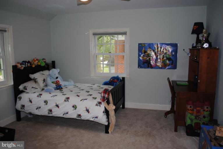 5803 Kenmore Road Baltimore, MD 21210 - Photo 7 of 29 a bedroom with a bed and furniture