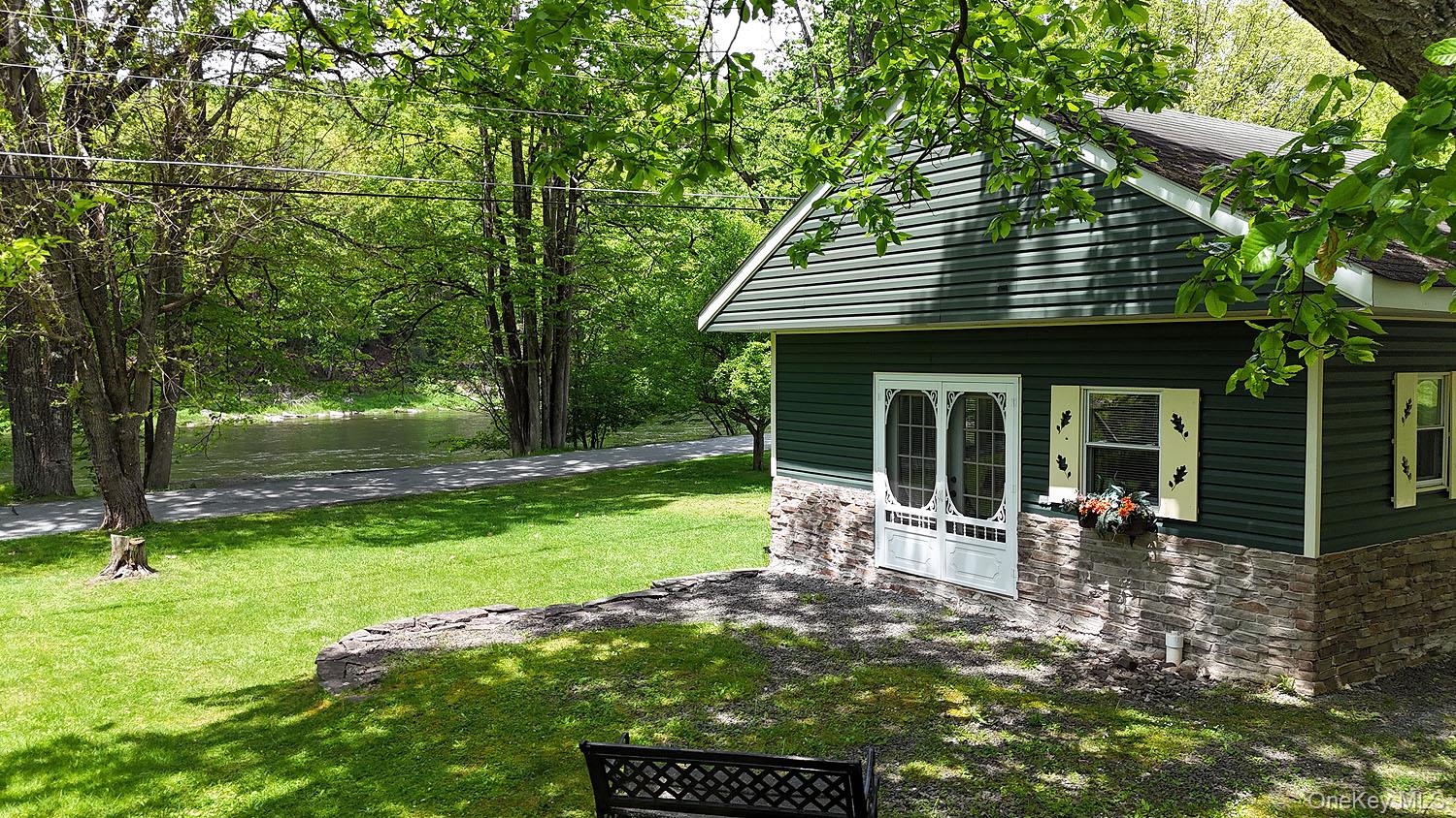 860 River Road Callicoon, NY 12723 - Photo 1 of 45 a view of a house with backyard porch and sitting area