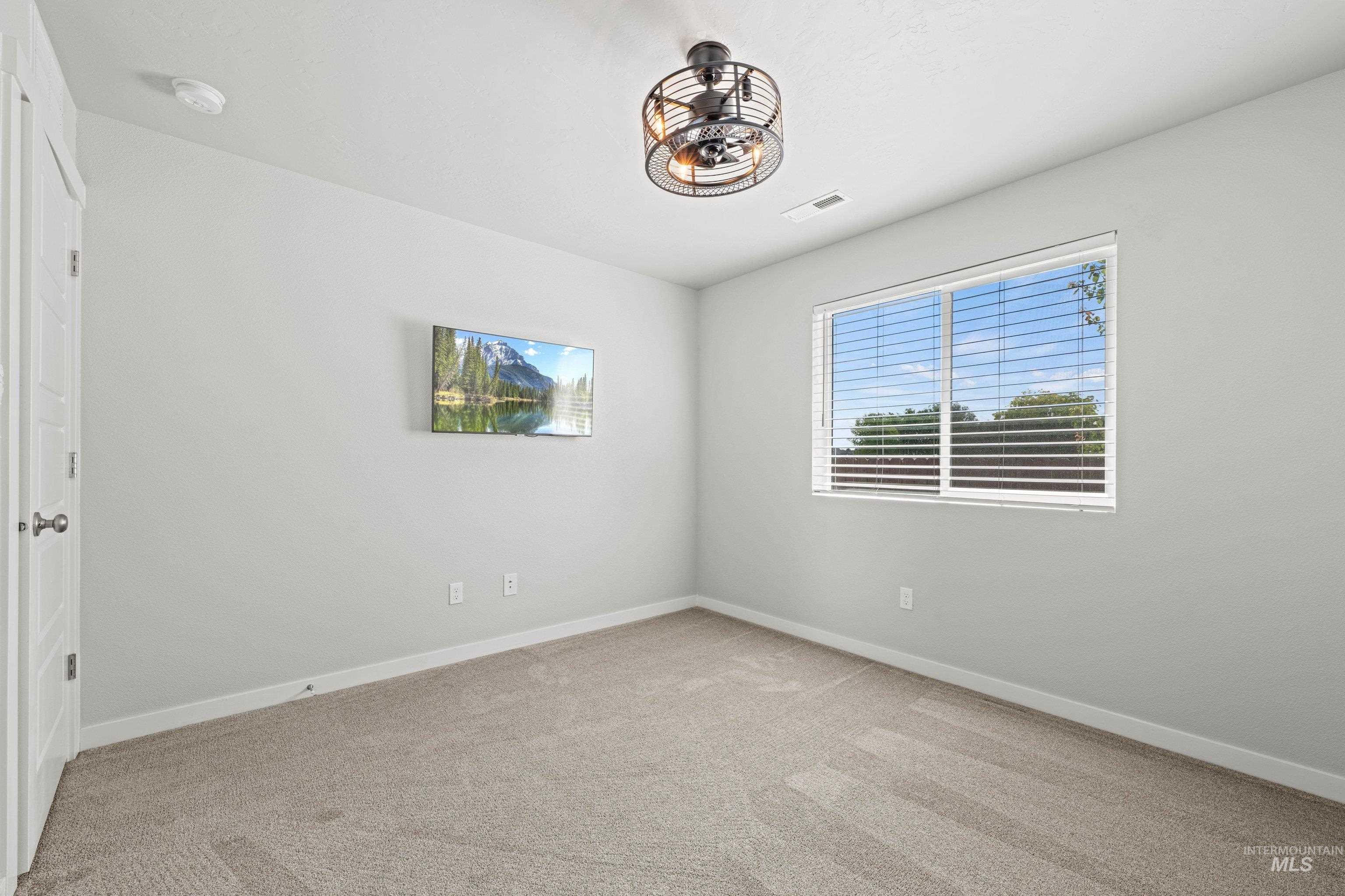 12744 West Fig Street Boise, ID 83713 - Photo 24 of 34 Carpeted room featuring a ceiling fan, white trim, and a window with horizontal blinds