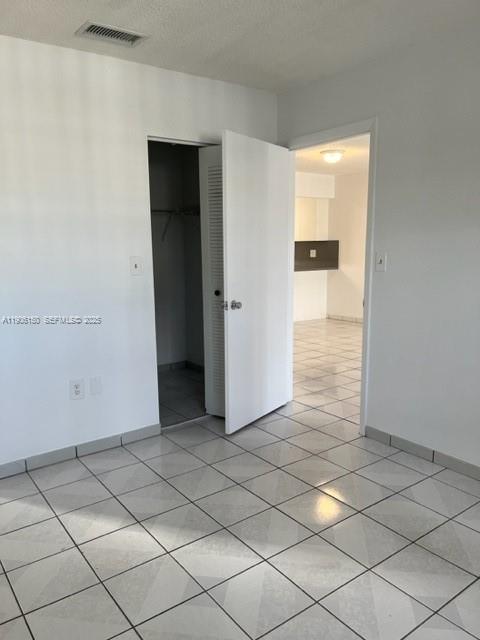 961 West 44th Street Hialeah, FL 33012 - Photo 23 of 35 a view of hallway with a white cabinet and a refrigerator