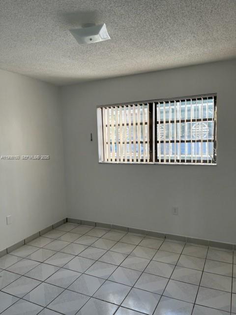 961 West 44th Street Hialeah, FL 33012 - Photo 9 of 35 an empty room with windows