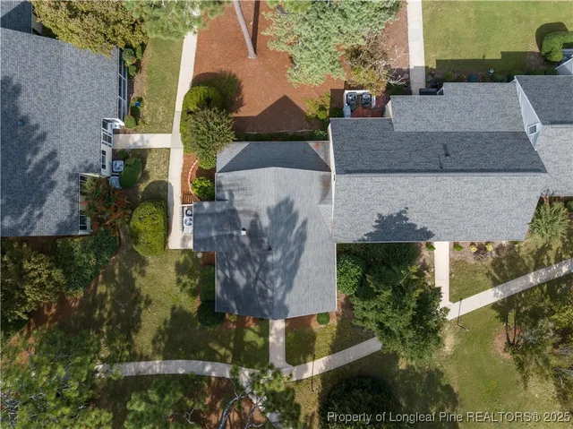 an aerial view of a house with a yard