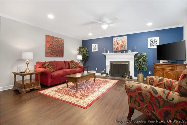 a living room with furniture a flat screen tv and a fireplace