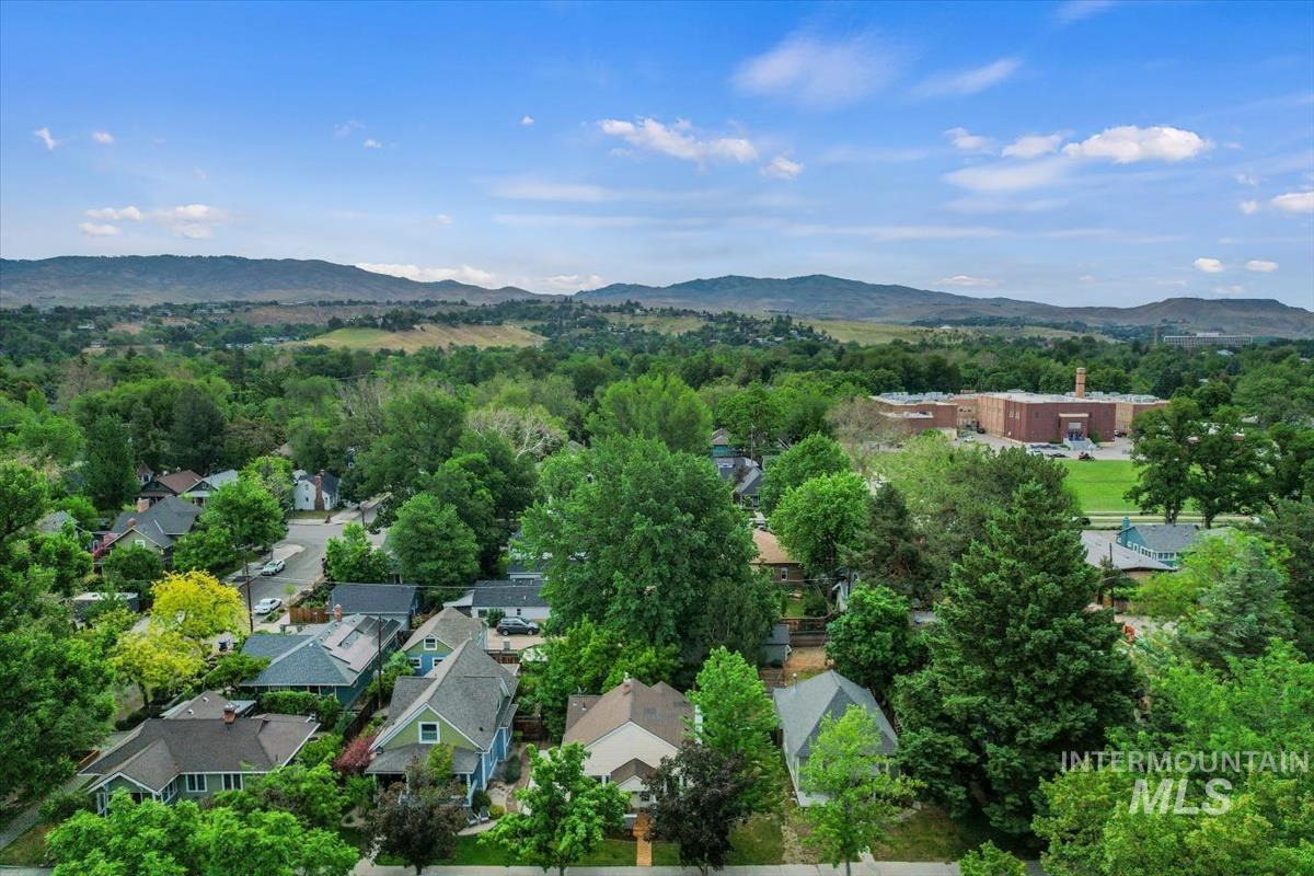 910 North 16th Street Boise, ID 83702 - Photo 41 of 47 Aerial perspective showcasing a residential area with varied home styles, mature trees, and mountainous terrain