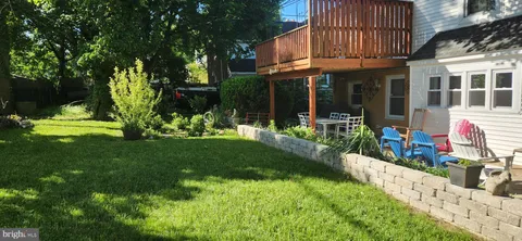 a view of a house with backyard sitting area and garden