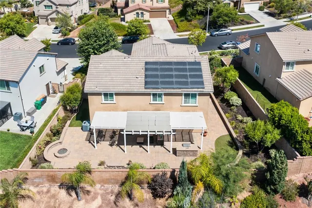 an aerial view of a house with a yard and potted plants