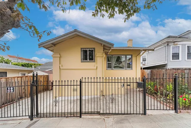 a view of a house with wooden fence