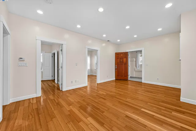 a view of an empty room with wooden floor