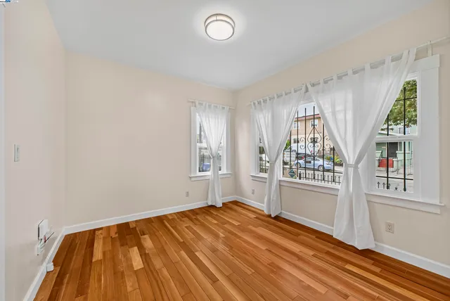 a view of a room with wooden floor and white walls