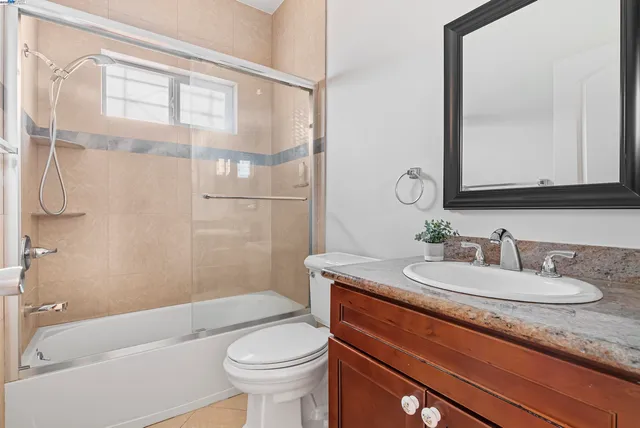 a bathroom with a sink mirror vanity and toilet