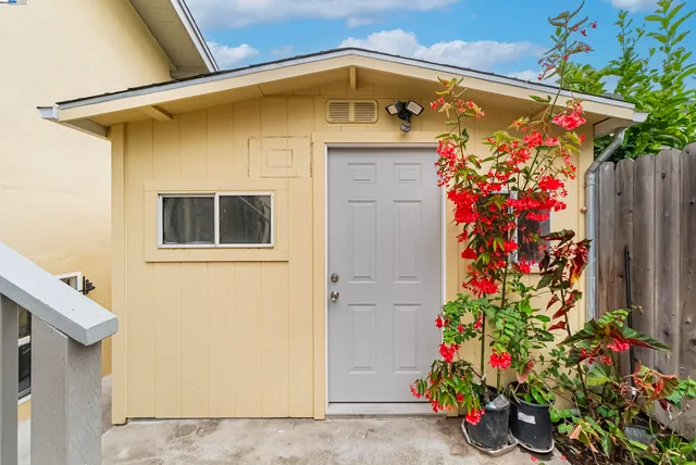 a view of cabinets with kitchen island a sink a stove and a refrigerator