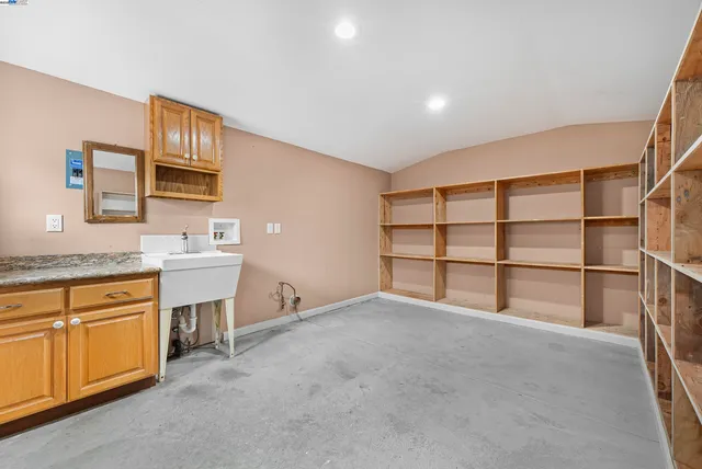 a view of a kitchen with chairs and cabinets