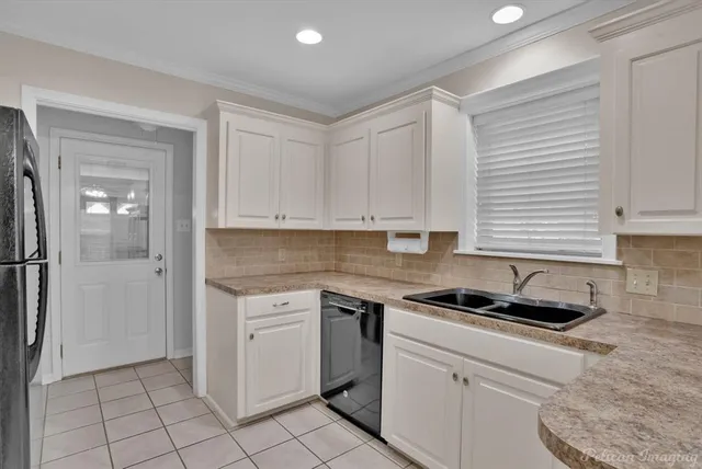a kitchen with cabinets appliances and a window