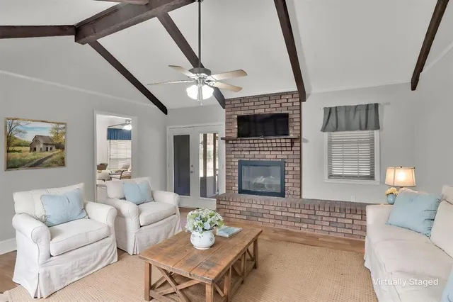 a living room with furniture and a fireplace