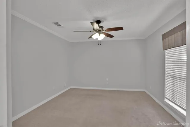 a view of a room with a ceiling fan and a window