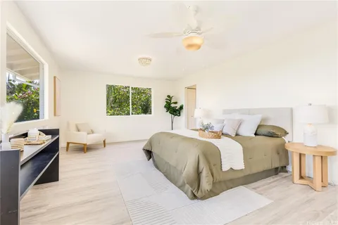 a spacious bedroom with a bed and a couch