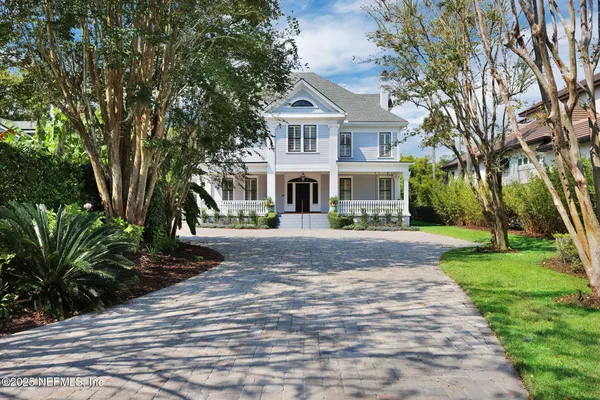 a view of a house with swimming pool and garden