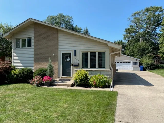 a front view of house with a garden