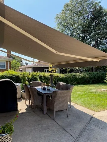 a patio with table and chairs