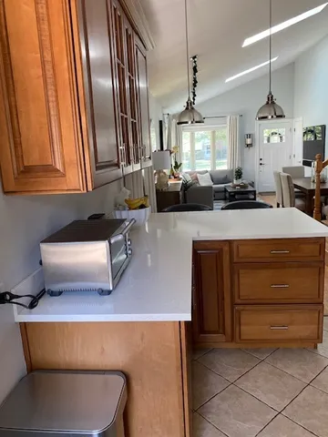 a kitchen with kitchen island a counter top space and a sink