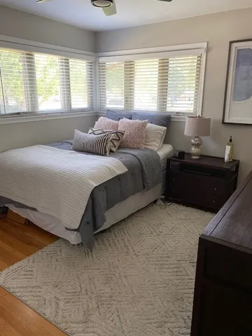 a spacious bedroom with a bed and window