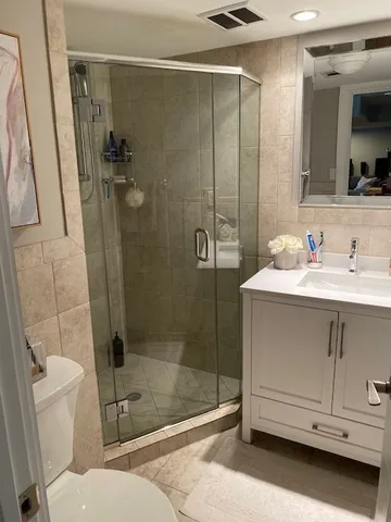 a bathroom with a sink toilet and shower