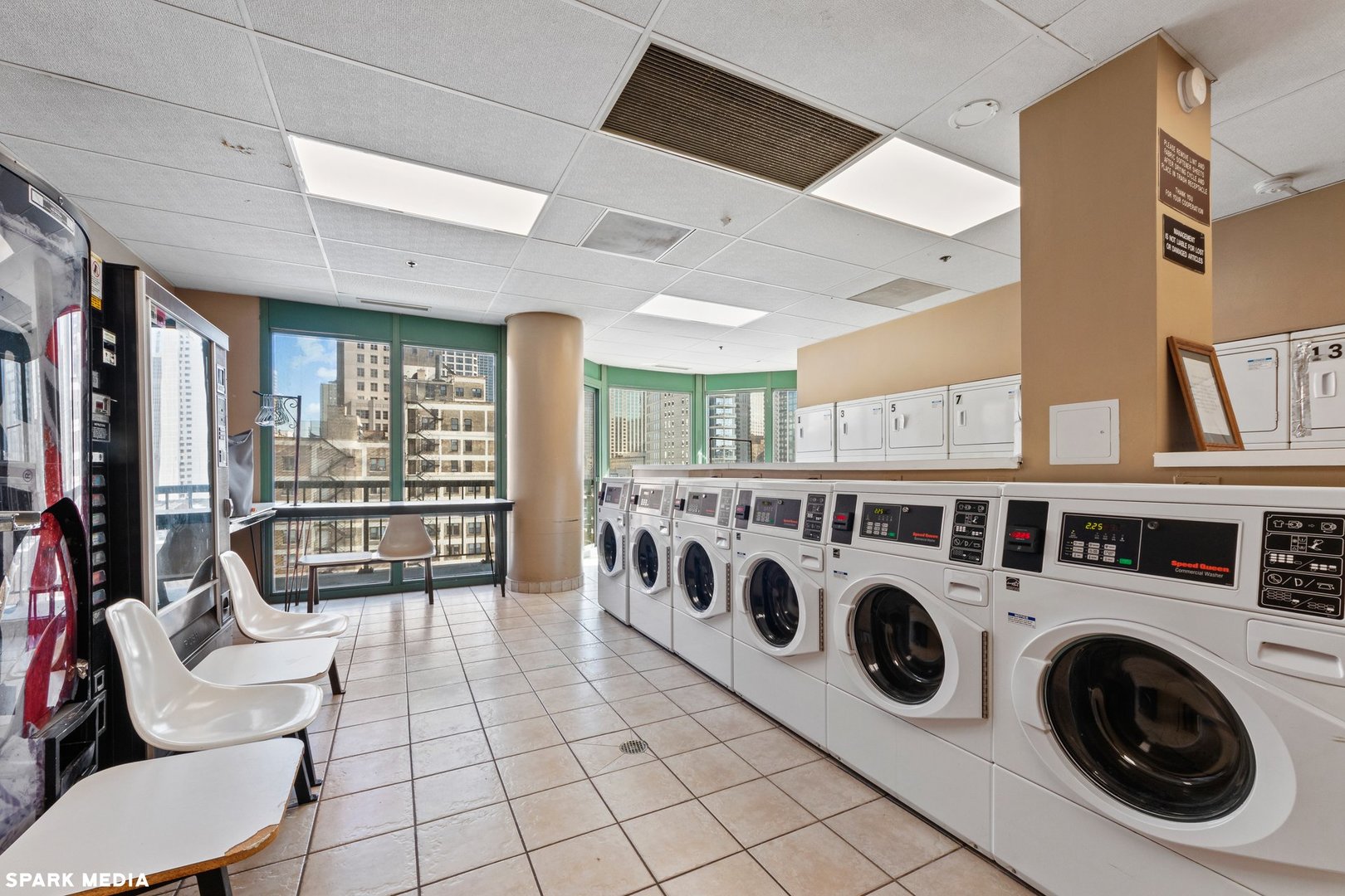 111 West Maple Street, Unit 1009 Chicago, IL 60610 - Photo 15 of 18 a utility room with stainless steel appliances wooden floor and washer