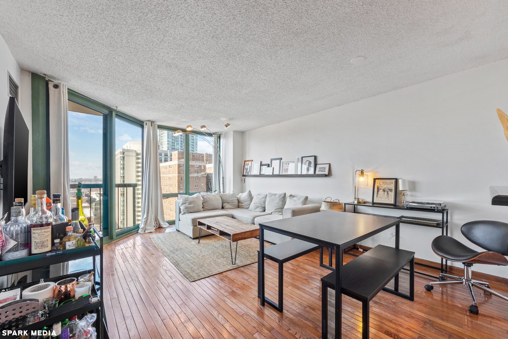 111 West Maple Street, Unit 1009 Chicago, IL 60610 - Photo 2 of 18 a living room with furniture and a flat screen tv