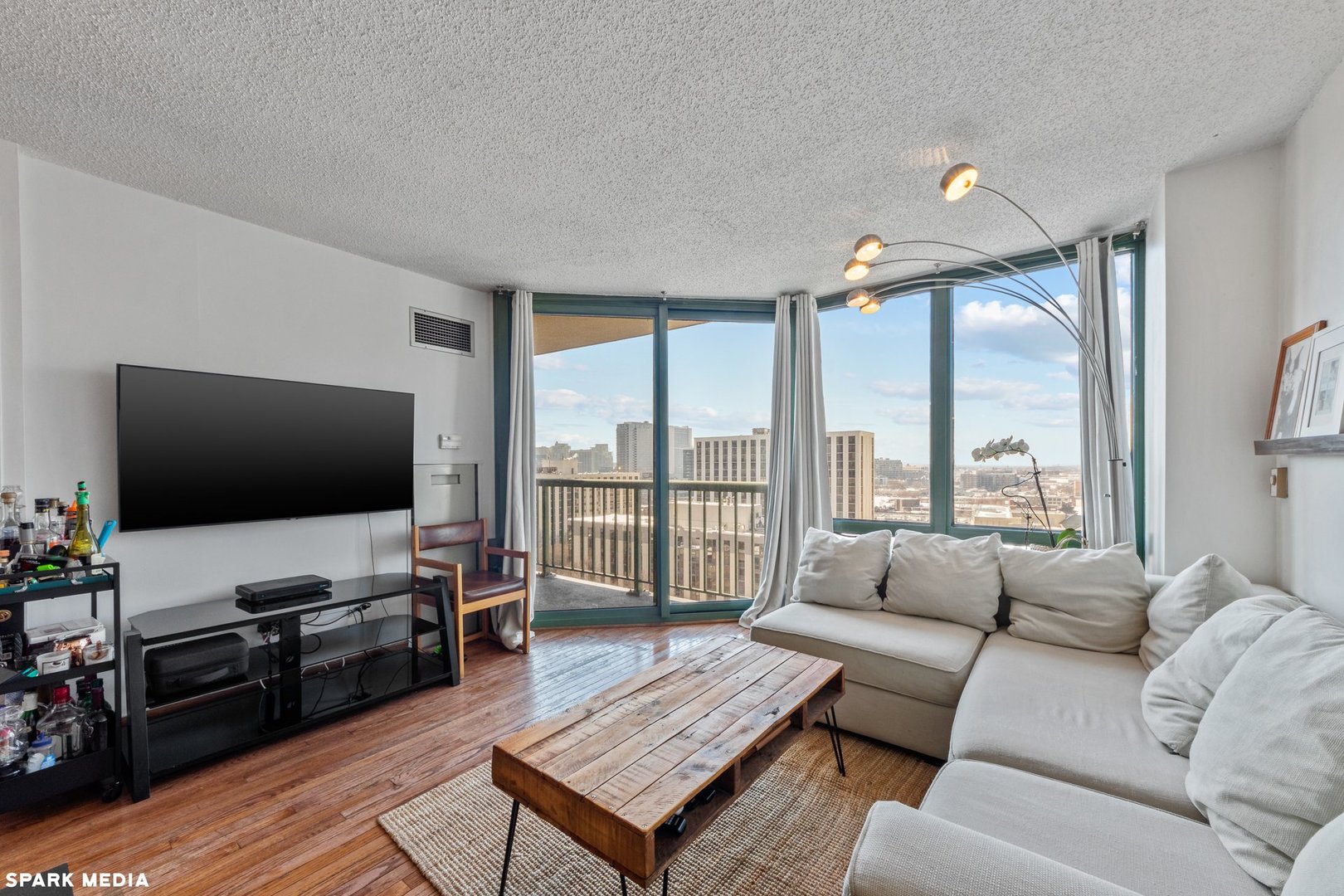 111 West Maple Street, Unit 1009 Chicago, IL 60610 - Photo 3 of 18 a living room with furniture and a flat screen tv
