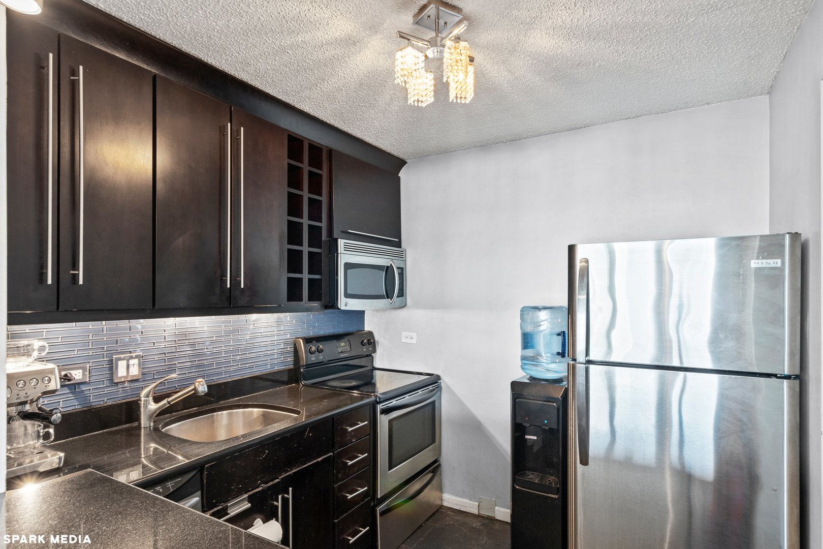 111 West Maple Street, Unit 1009 Chicago, IL 60610 - Photo 5 of 18 a kitchen with a refrigerator and a sink