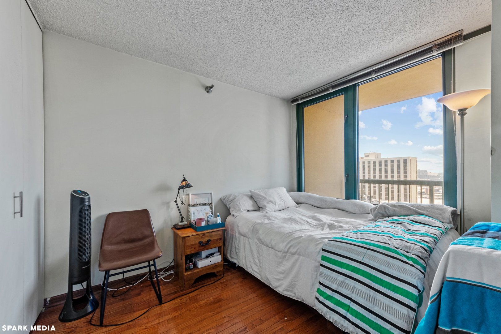 111 West Maple Street, Unit 1009 Chicago, IL 60610 - Photo 8 of 18 a bedroom with a bed and windows