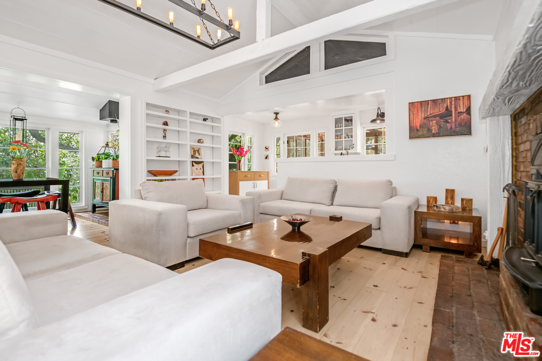21042 Entrada Road Topanga, CA 90290 - Photo 2 of 49 a living room with furniture and a flat screen tv