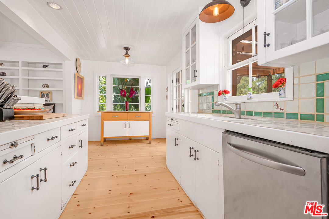 21042 Entrada Road Topanga, CA 90290 - Photo 20 of 49 a kitchen with cabinets a sink and a window