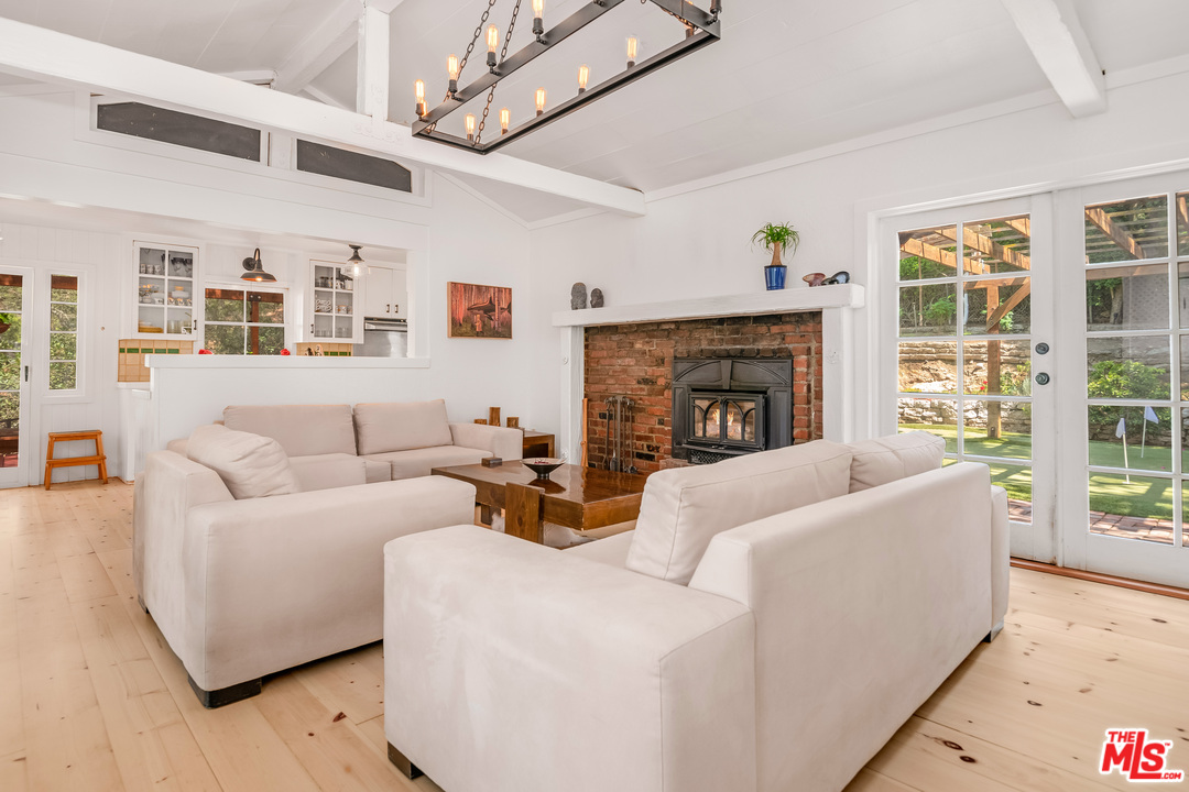 21042 Entrada Road Topanga, CA 90290 - Photo 3 of 49 a living room with furniture and a fireplace