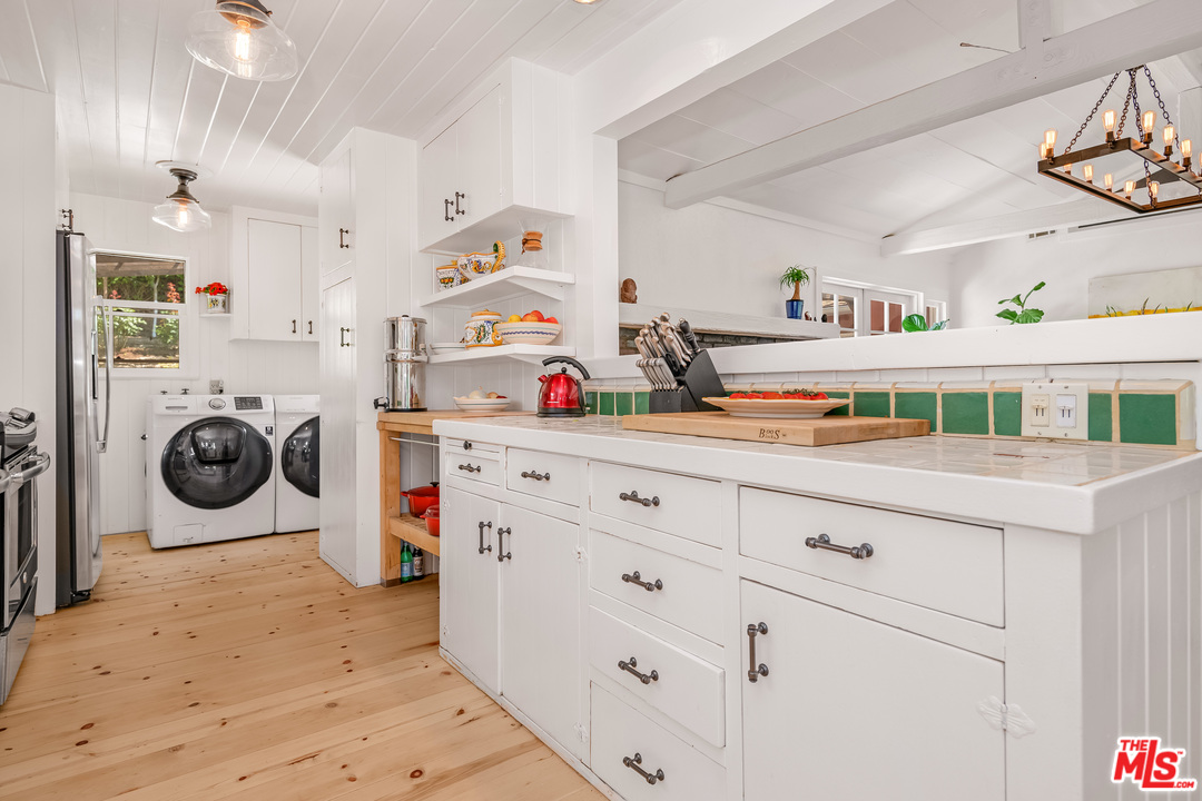 21042 Entrada Road Topanga, CA 90290 - Photo 22 of 49 a utility room with dryer and washer