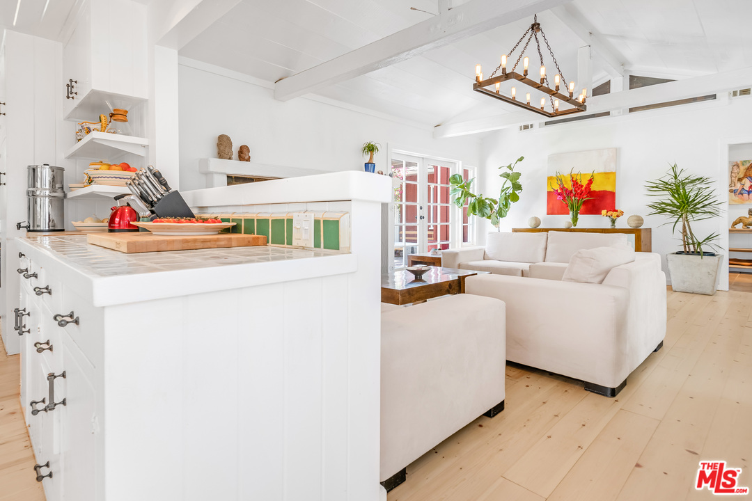 21042 Entrada Road Topanga, CA 90290 - Photo 4 of 49 a living room with furniture and a chandelier