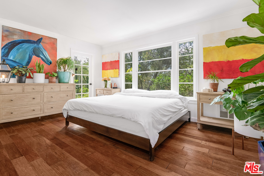 21042 Entrada Road Topanga, CA 90290 - Photo 32 of 49 a bed sitting in a bedroom next to a window