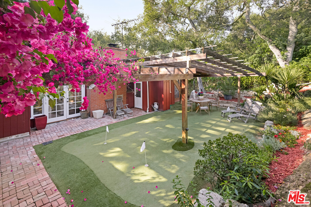 21042 Entrada Road Topanga, CA 90290 - Photo 38 of 49 a view of a swimming pool with a patio