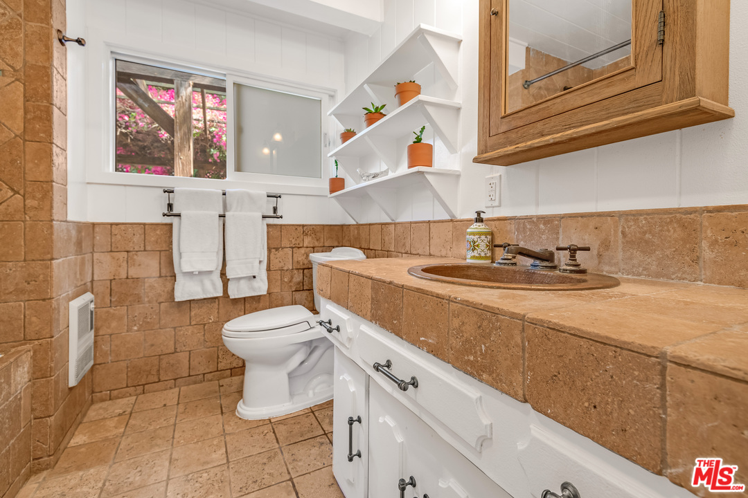 21042 Entrada Road Topanga, CA 90290 - Photo 39 of 49 a bathroom with a sink toilet and shower